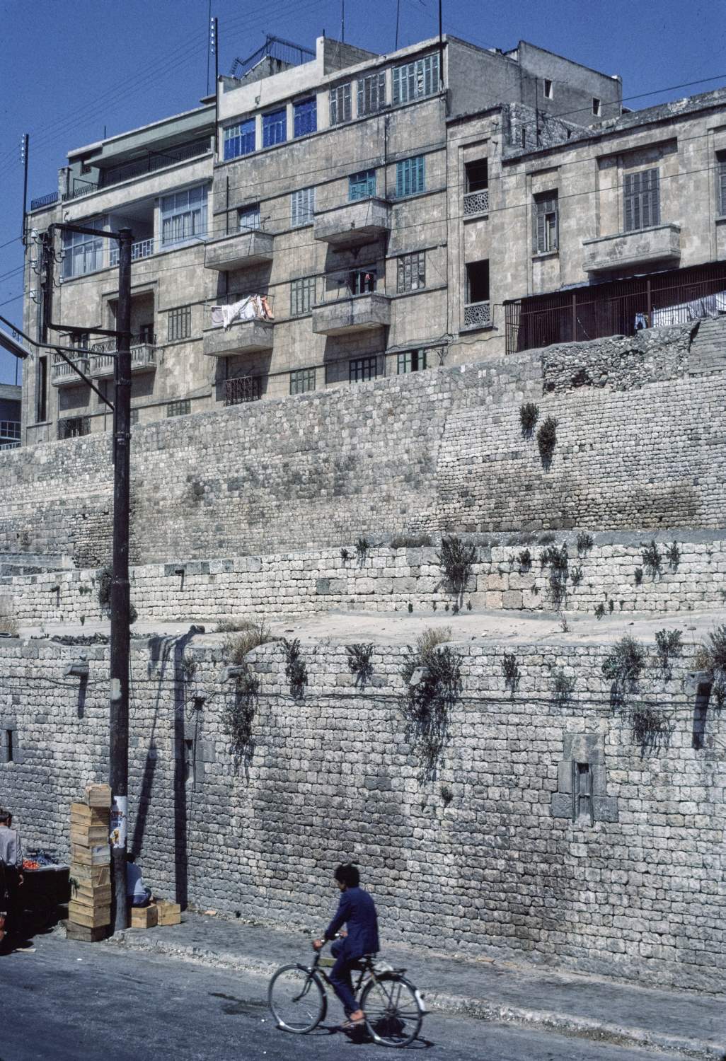 View of walls and modern buildings rising behind.