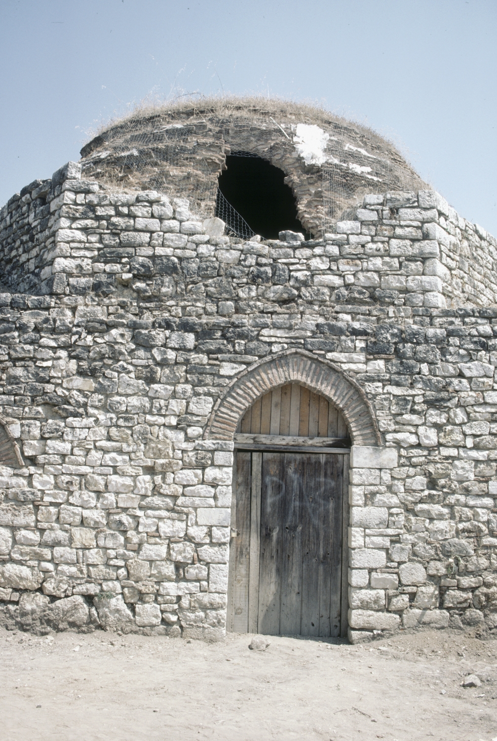 Exterior, view of entrance door and damaged dome