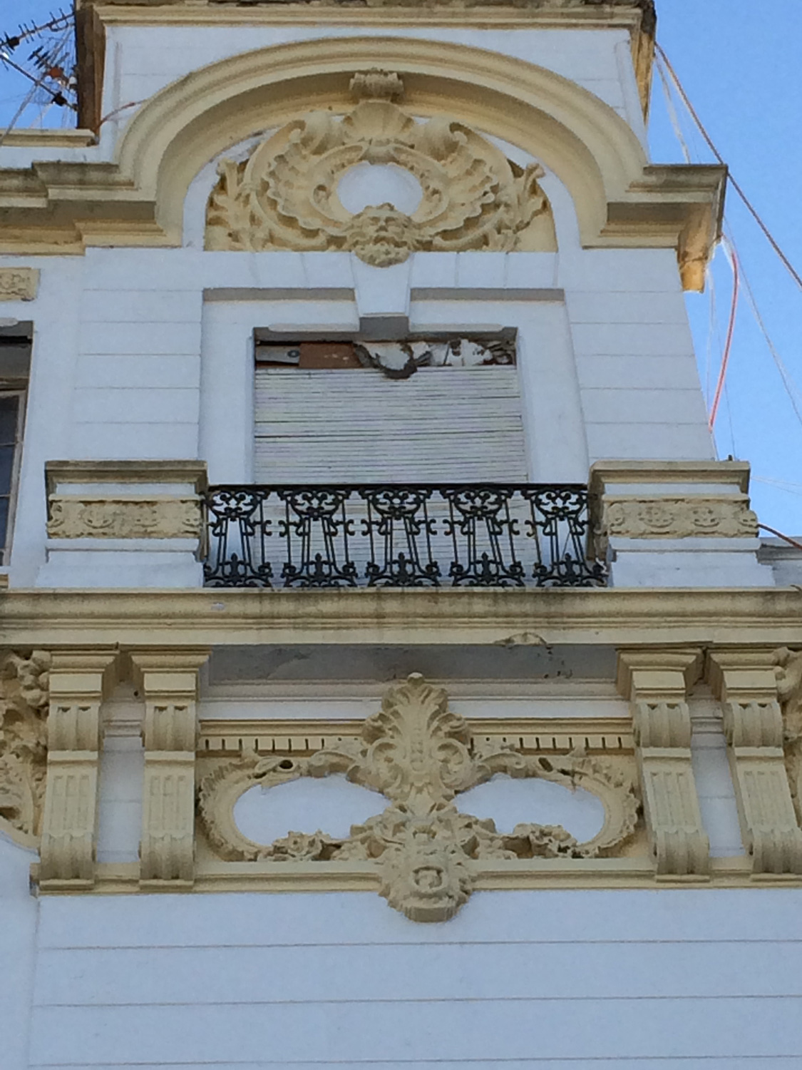 Detail view of the decorations on the window at the top of the northeast corner of the facade