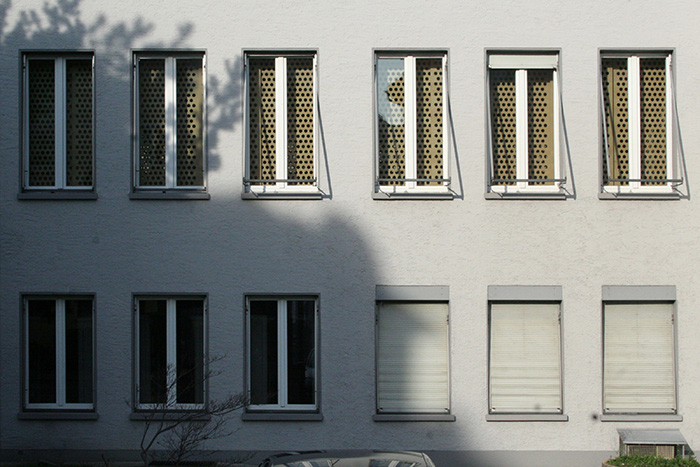 Wooden blinds indicating change on the facade   