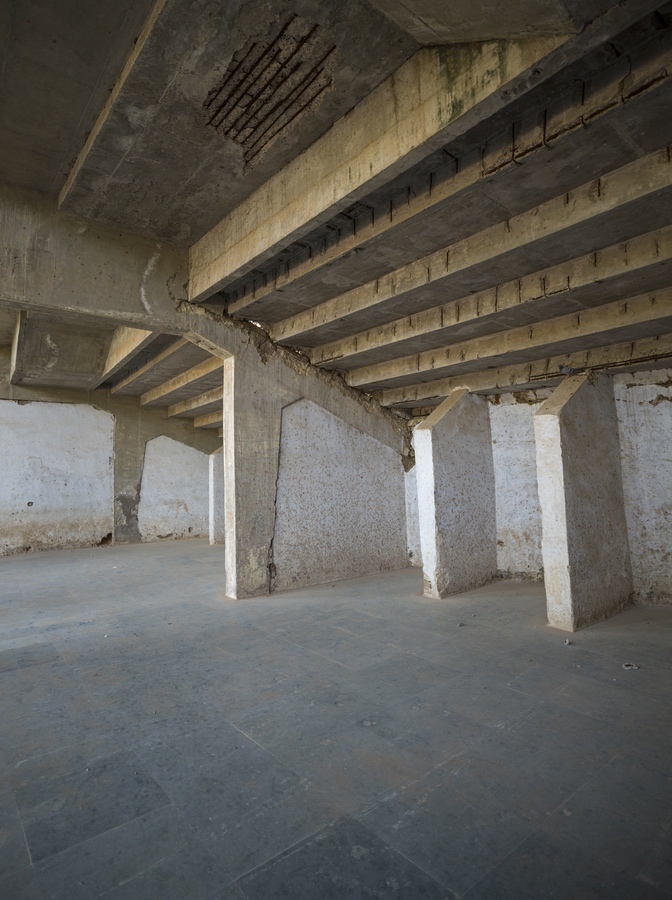 <p>Decaying structure below the stands with reinforcement bars exposed due to chipping off of concrete</p>