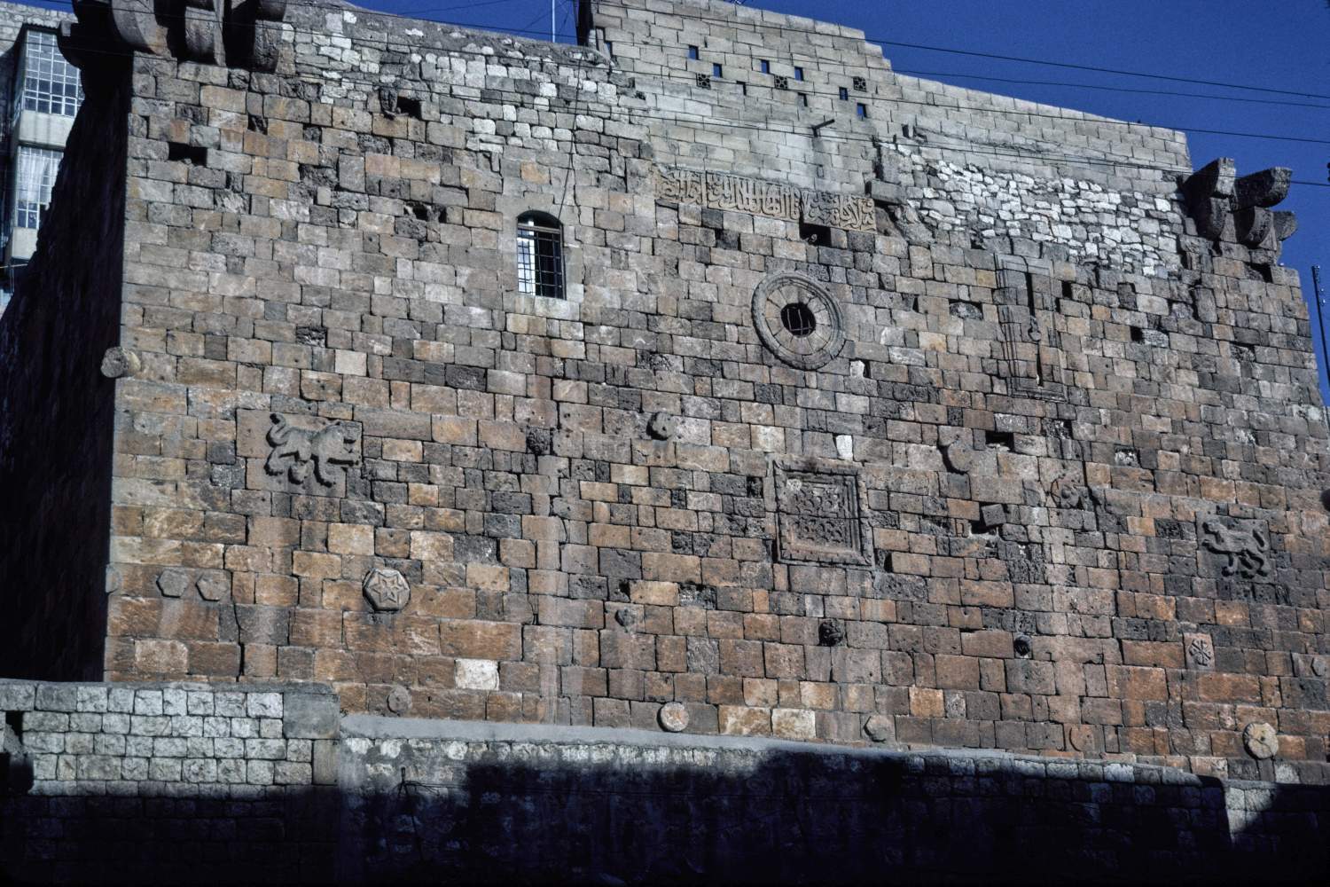 Bastion on west front north of Bab Antakiyya incorporating carved plaques and inscription band.