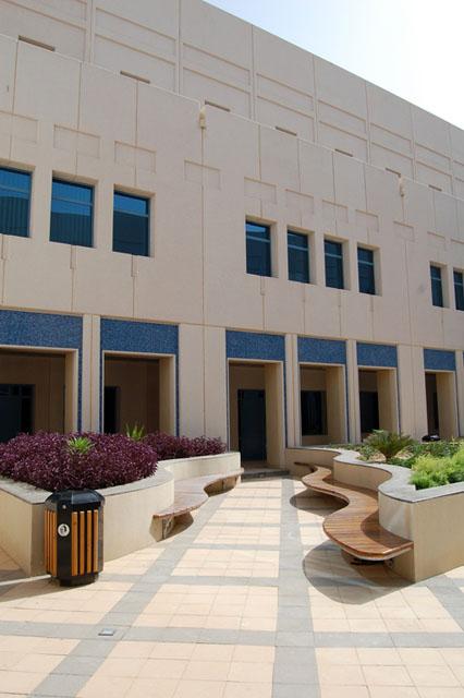 Classroom courtyards feature richly patterned paving and lush plantings in a traditional style