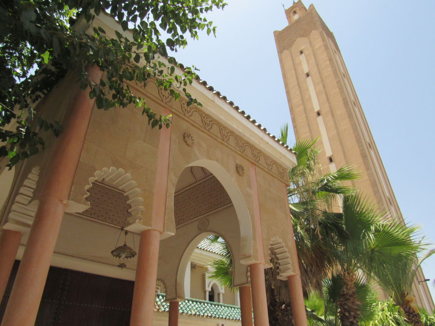 Exterior view from in front of the covered entrance toward the minaret