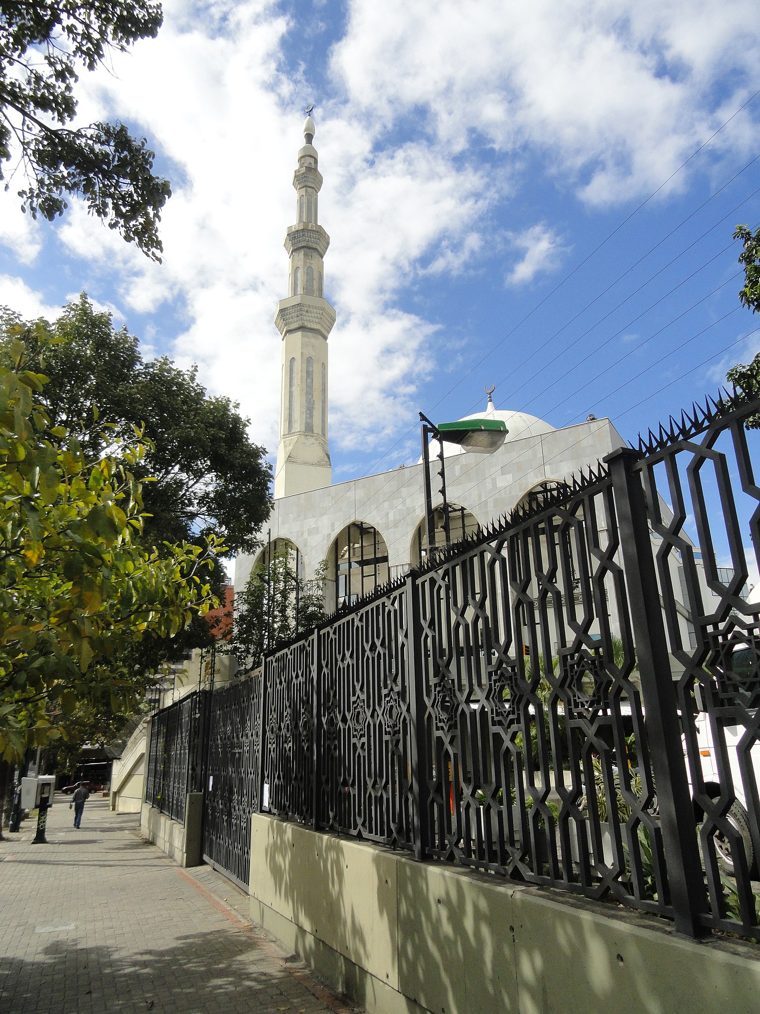 <p>View of the mosque through the fence off the street</p>