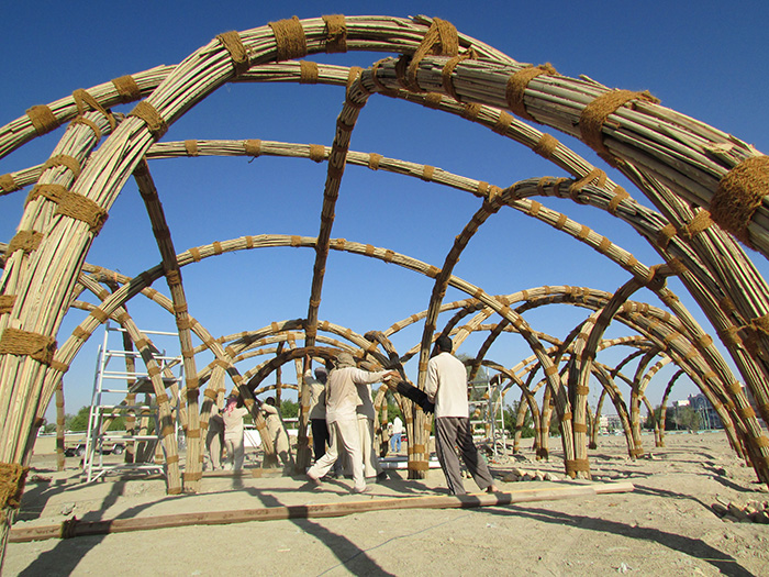 Final installation of palm leaf arches 