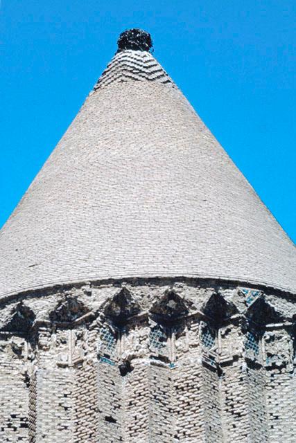 Exterior view showing the conical dome and remains of cornice tile work alternating between unglazed and glazed terracotta