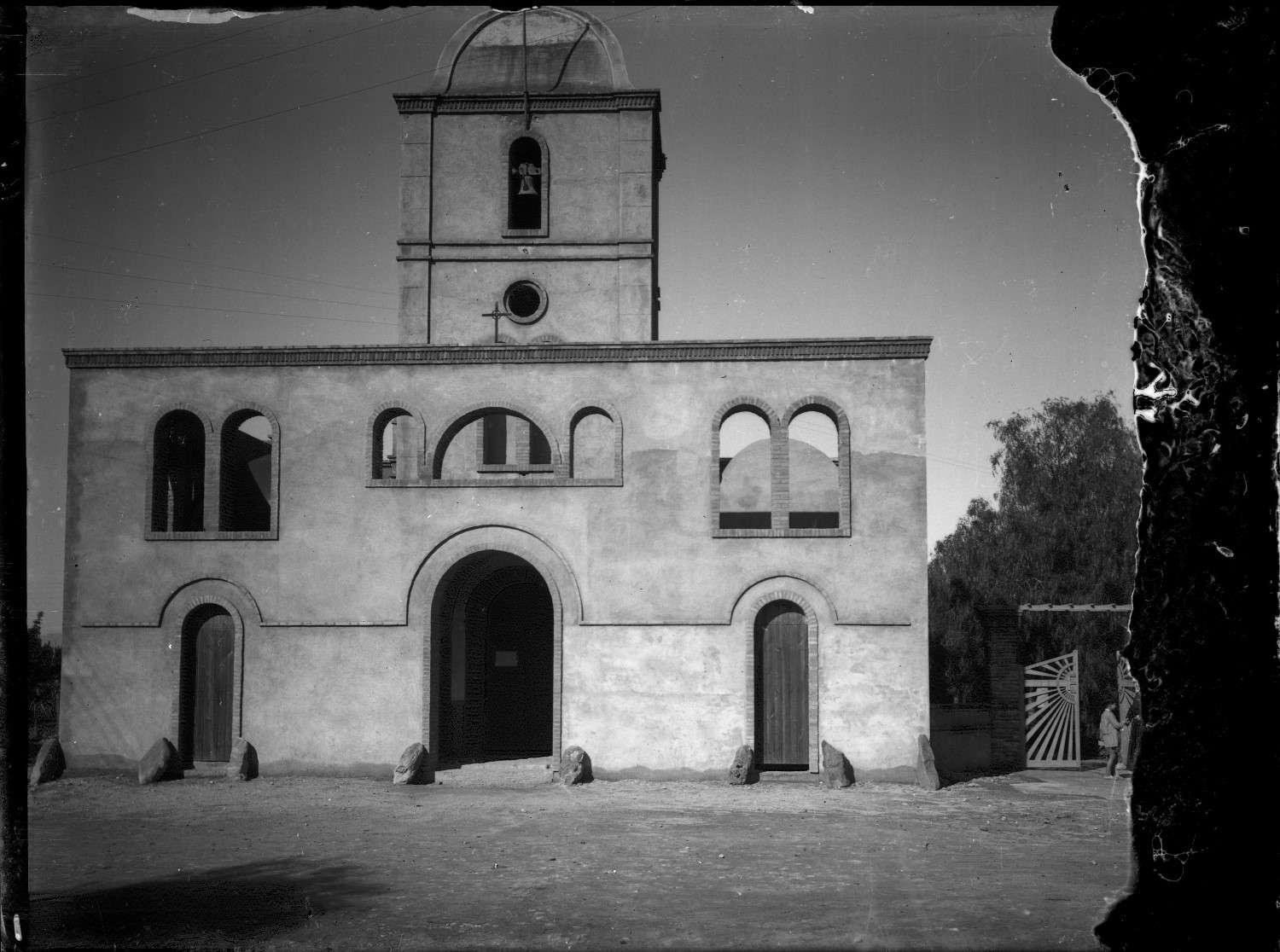 Church with gate, open facade with windows 