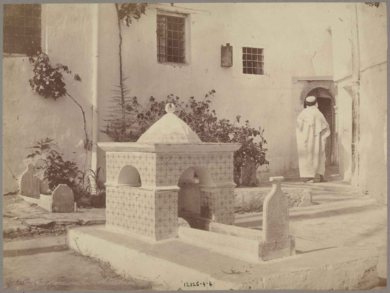 View of tombs and a man entering the door
