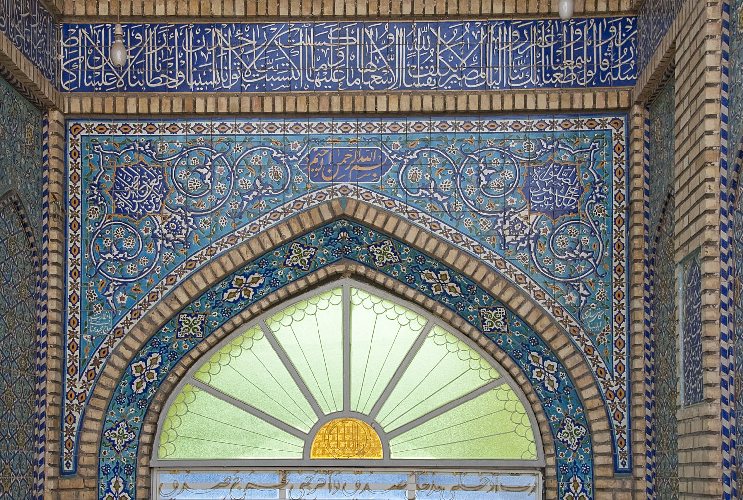 Entrance portal: view of lunette over doorway.