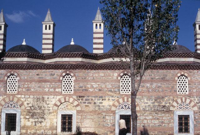 Exterior view, elevation of the madrasa with the domes and chimneys above