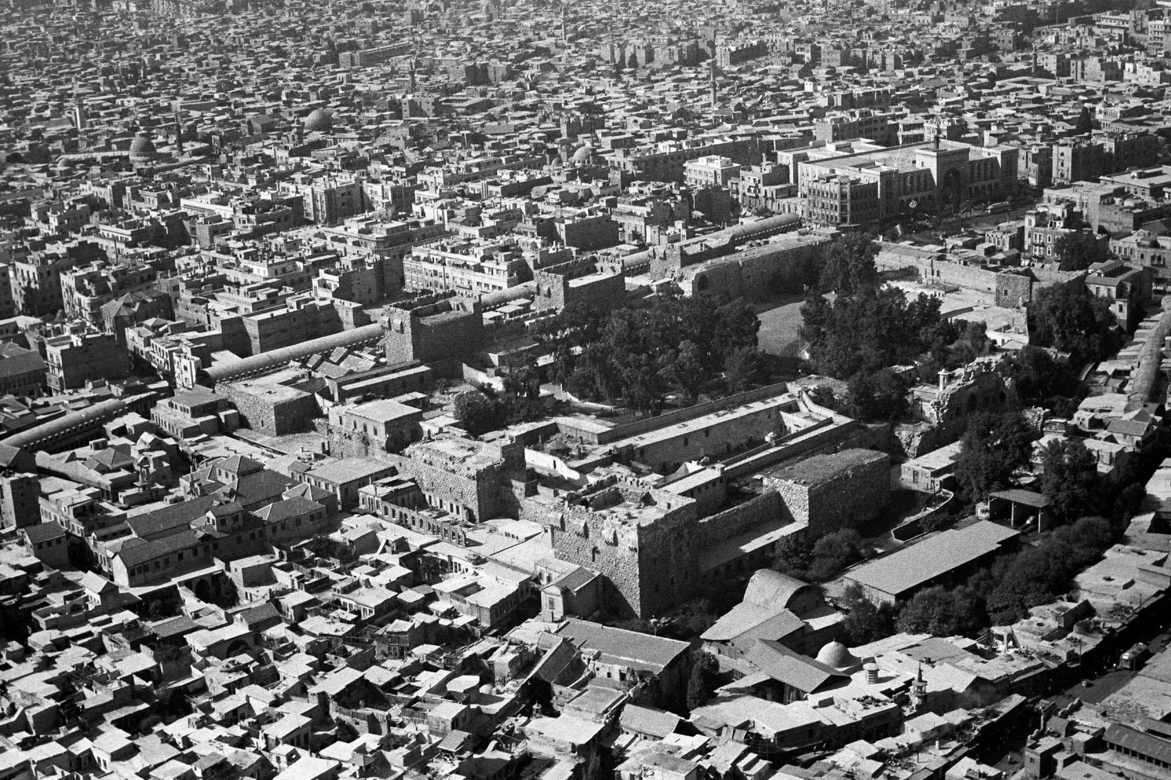 Aerial view of the city, with the Qal'a (Citadel) in the foreground 
