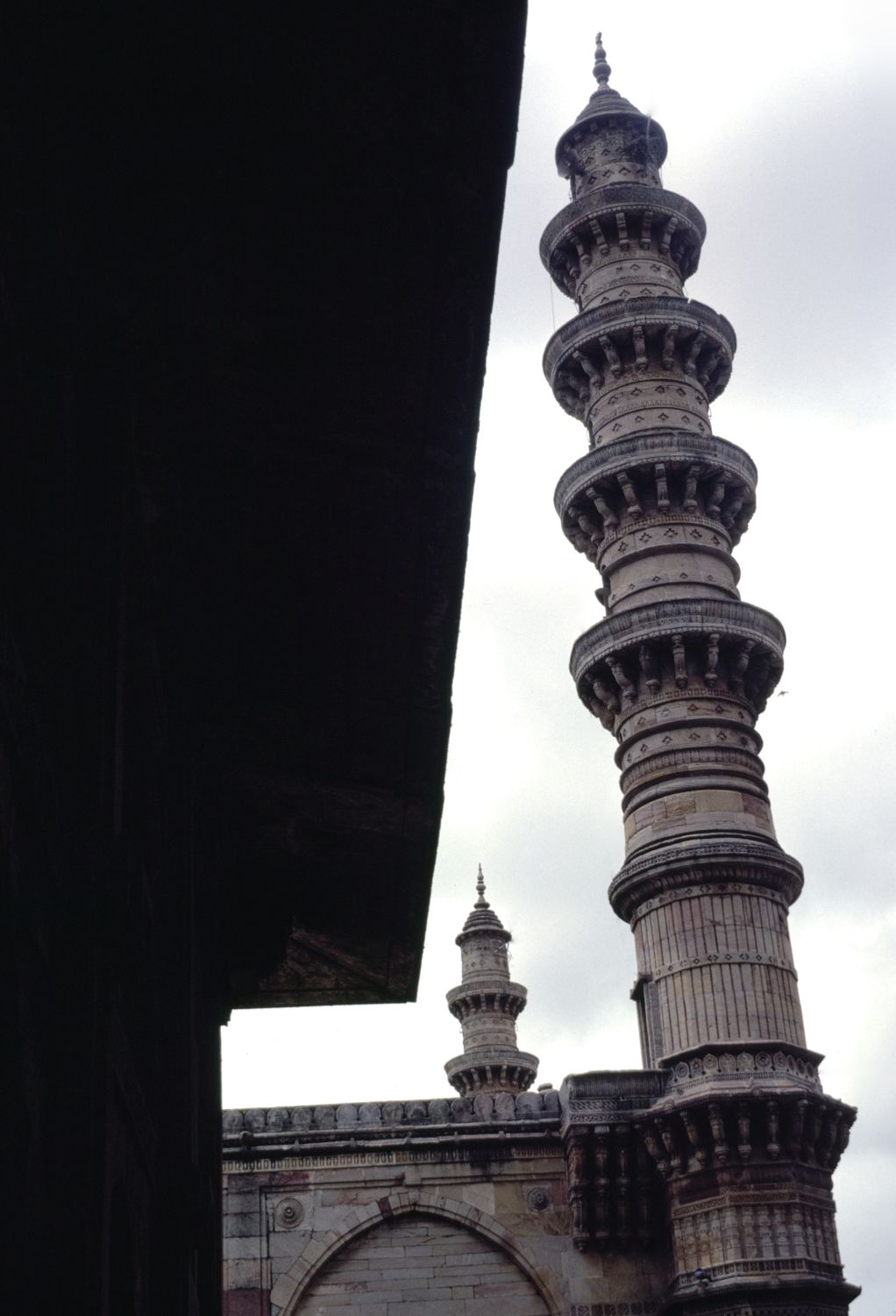 Mosque: view of south minaret from the porch of western tomb.