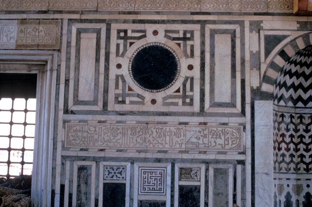 Detail view, marble decoration in portico on entrance wall with mihrab niche at right