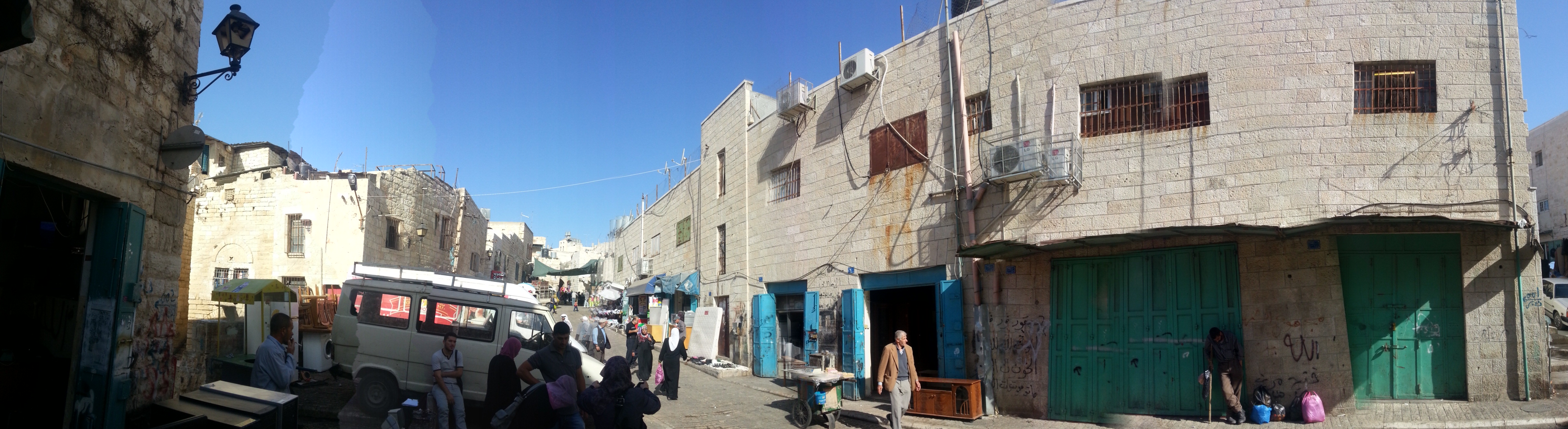 <p>Al-Najajreh Street general view. Mixed car-pedestrian movement, encroachment on the sidewalks by the shop keepers, building facades need renovation &amp; tidiness.</p>
