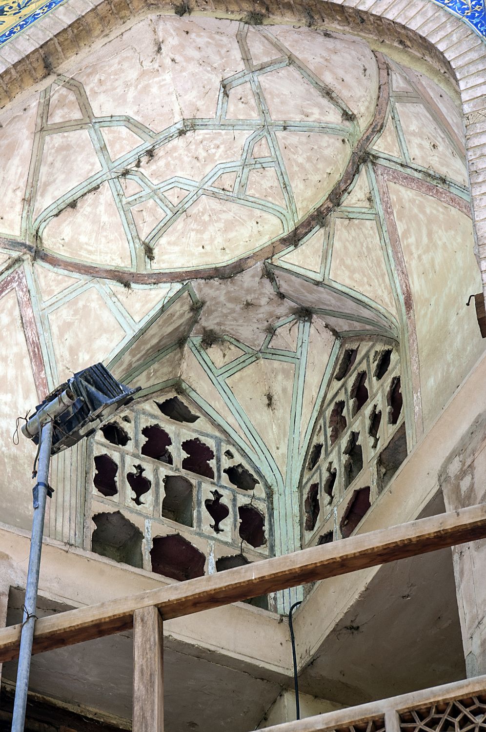 Northwest corner of building, view into the arched opening of a second floor gallery showing vault and perforated stucco niches.