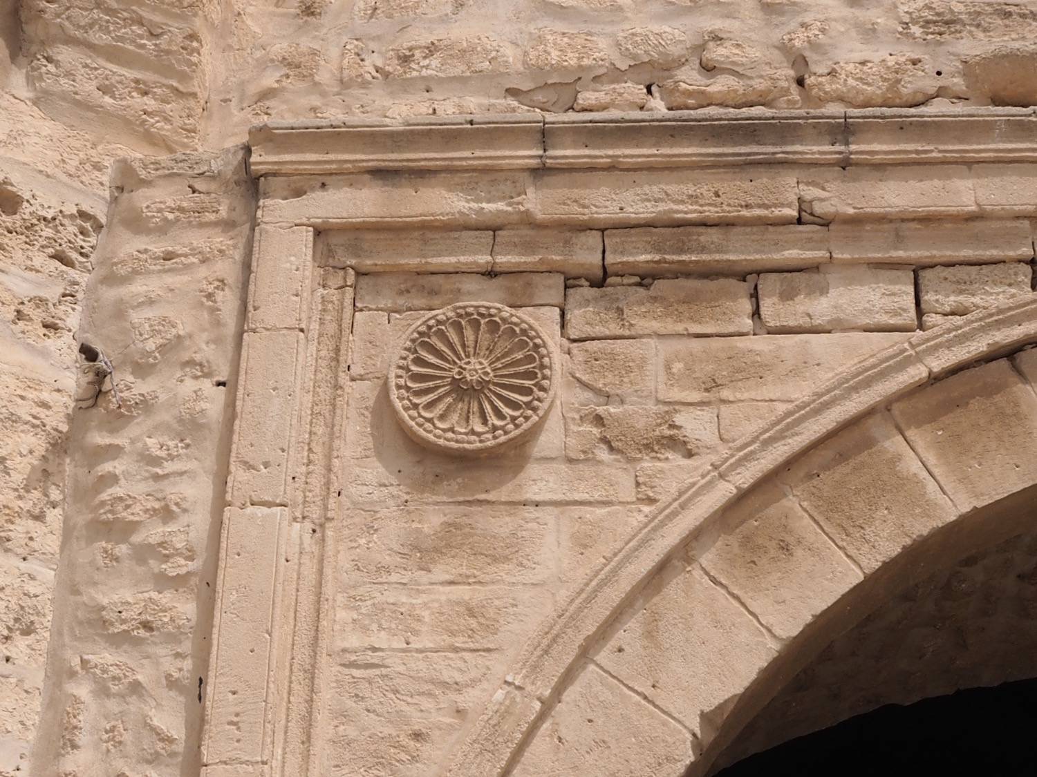 Detail view of a medallion in the frame above the arch