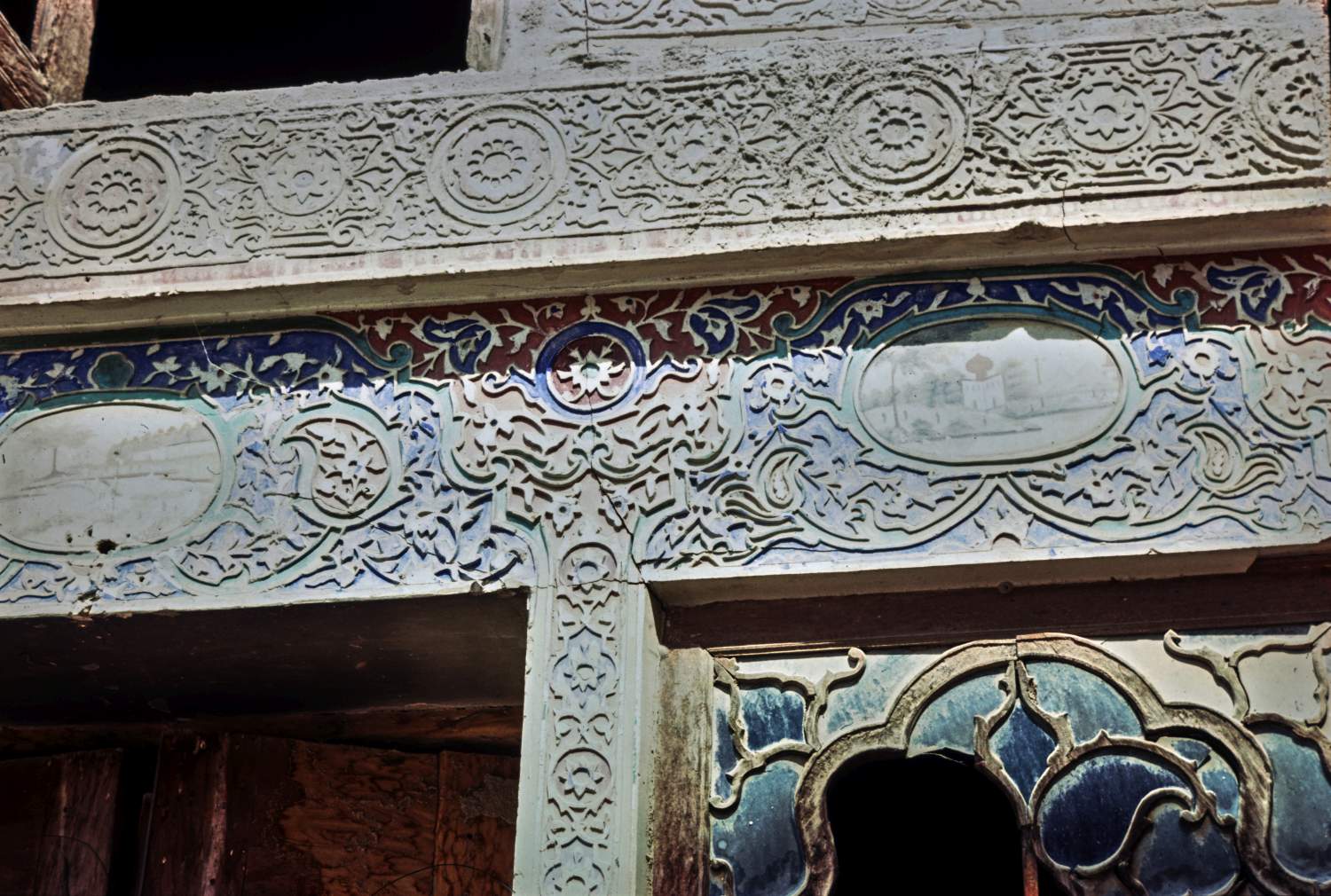 View of carved and painted stucco decoration on facade.