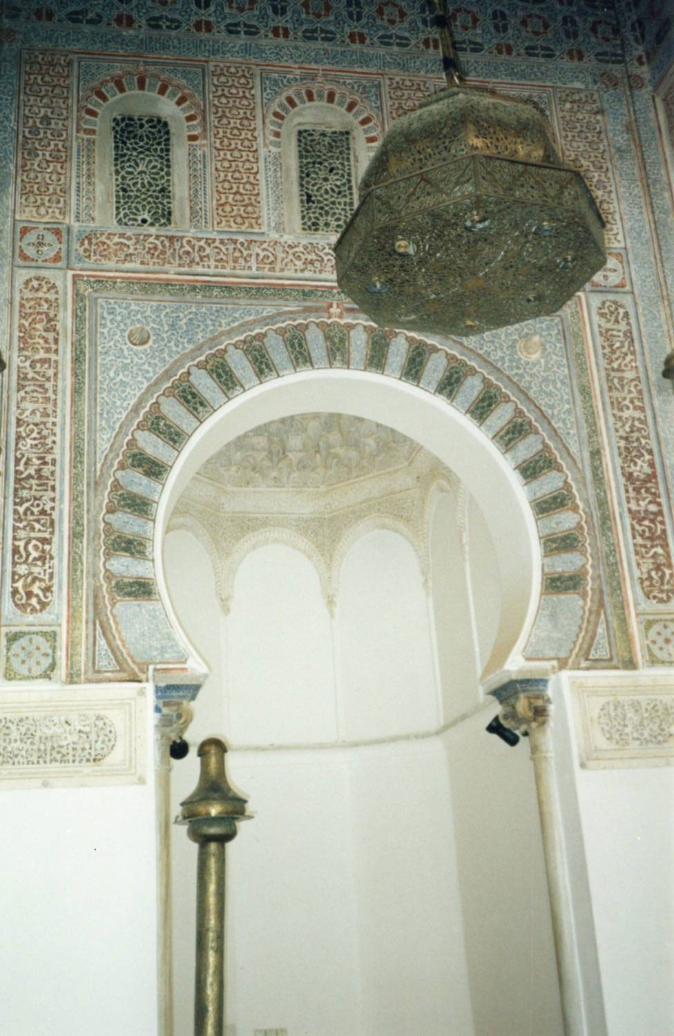 Mihrab of the mosque, decorated with carved stucco in calligraphic and floral motifs