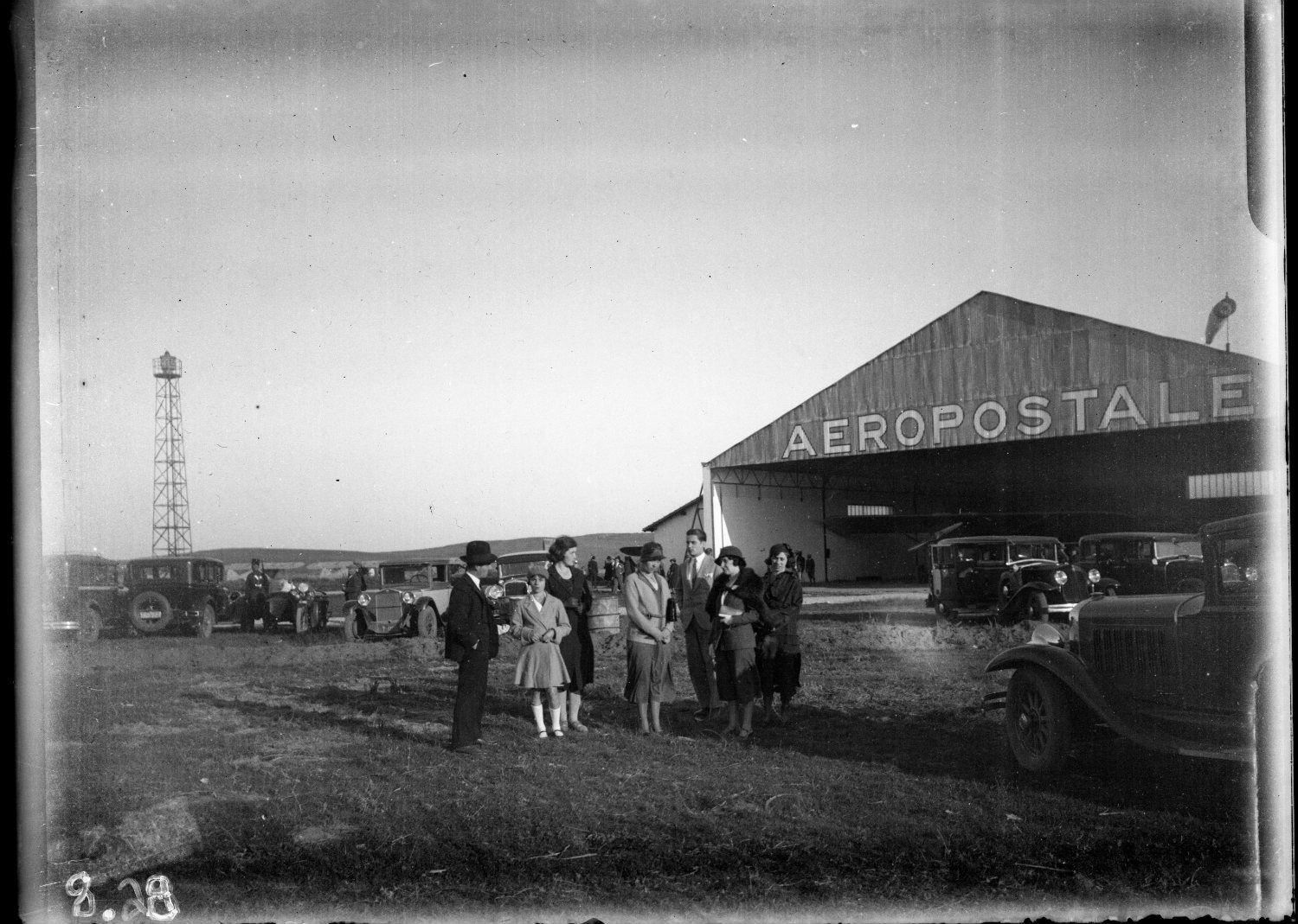 Aeroport Ibn Battouta de Tanger - Women, men and girl in European dress in front of aeropostale hanger, airplane inside