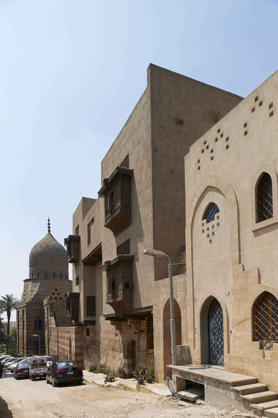 View along street facade, with tomb of Qanibay Amir Akhur in distance