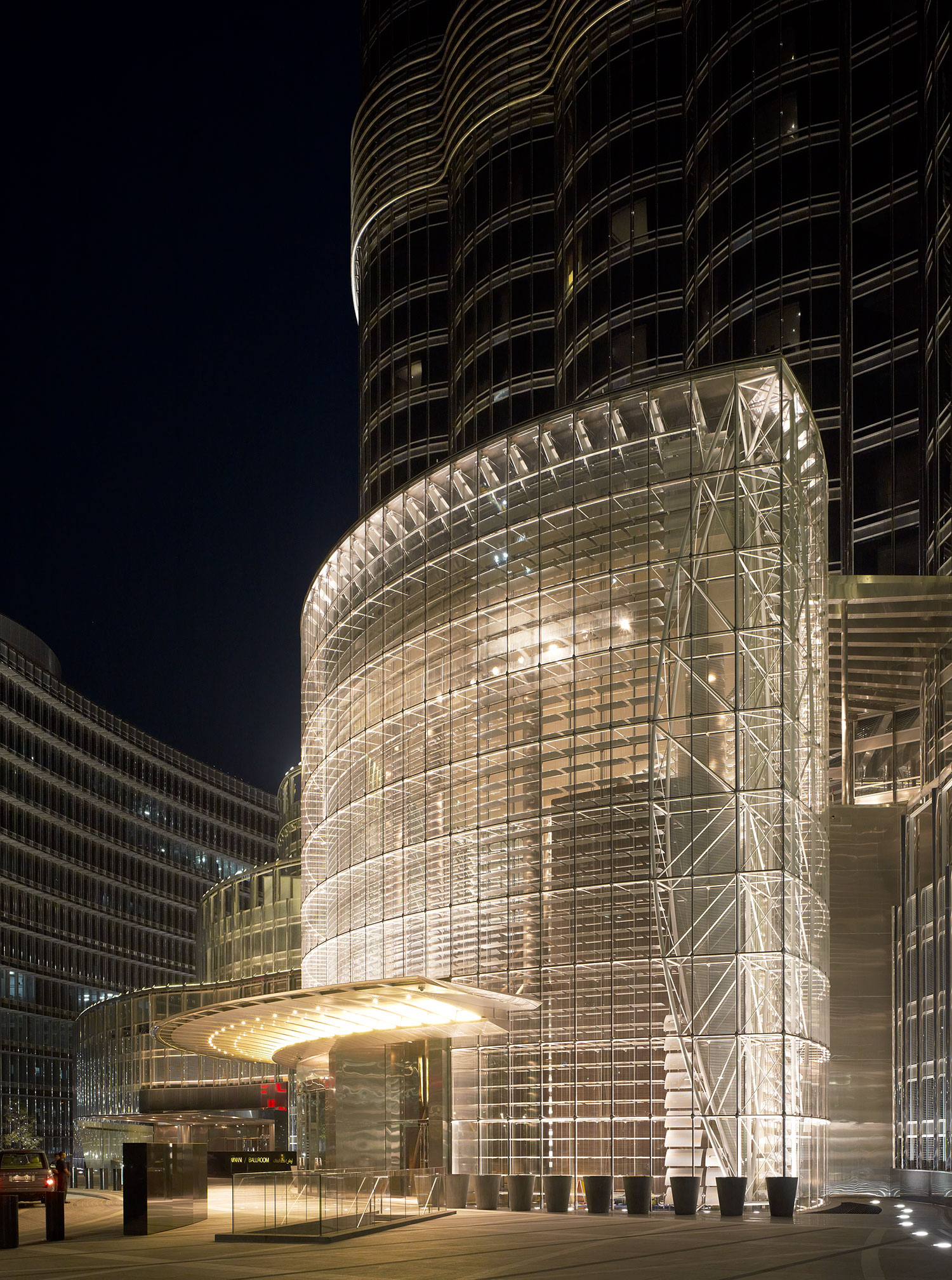 Exterior view of the Armani hotel entrance with glass curtain wall (evening)