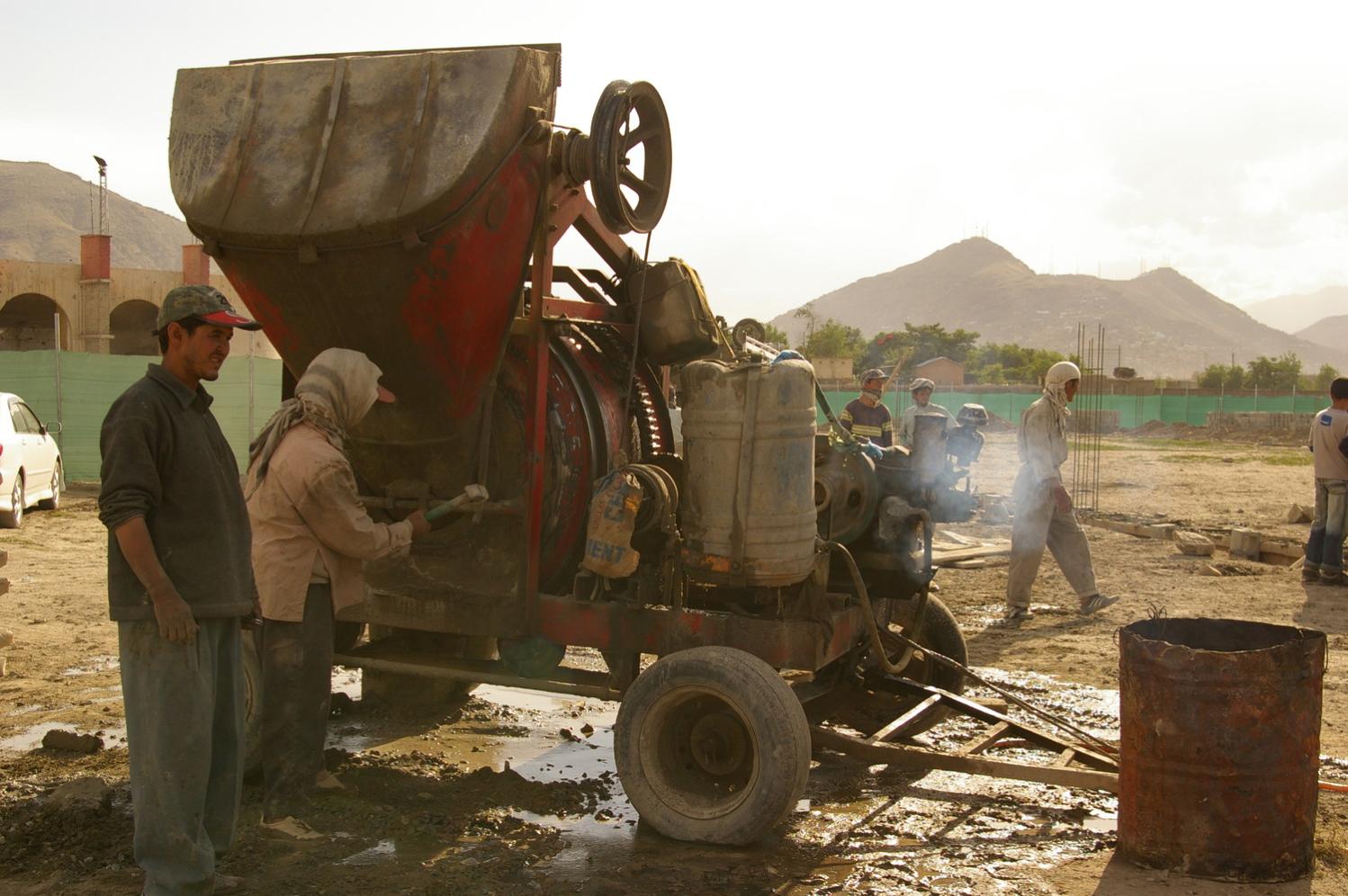 ACCL labourers mix cement for the foundation of the Skateistan Kabul facility