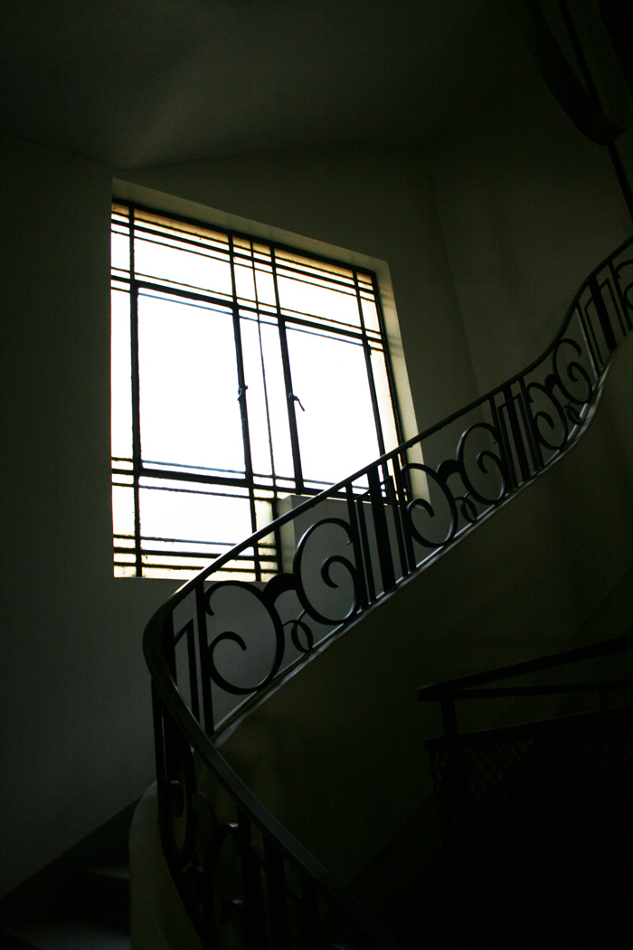 Interior, window and staircase with wrought iron geometrical forms