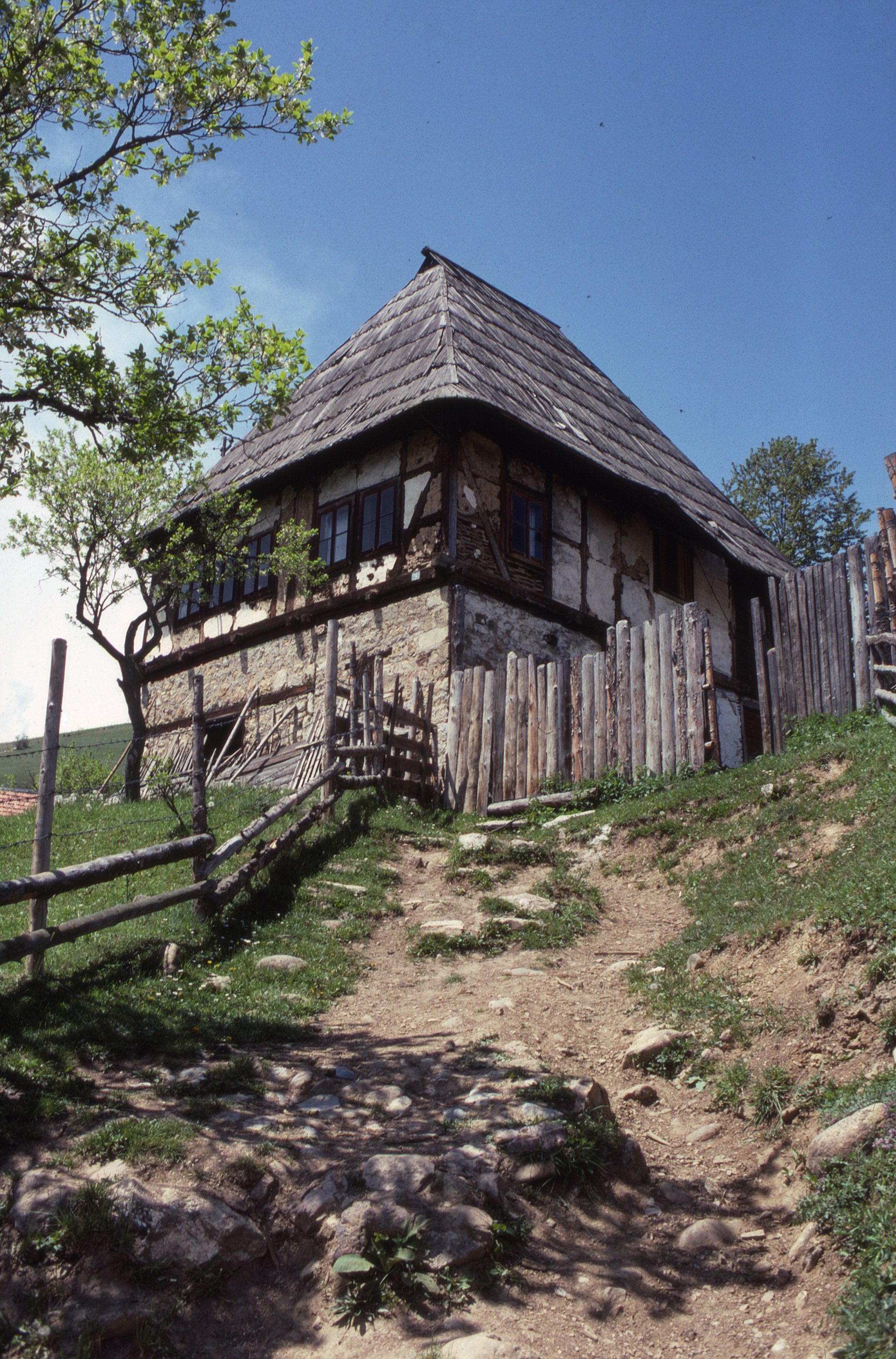 <p>The kuća has the typical roof profile of the dinaric dwelling. The lowest level, built into the sloping terrain was constructed of stone walls and its interior was divided into separate rooms to store food, tools, and house animals. The upper level was constructed with timber framed walls with wattle and daub infill covered with plaster. The living floor of the house has several windows, evidence of multiple rooms within. The roof was timber framed with wooden shingles.</p>