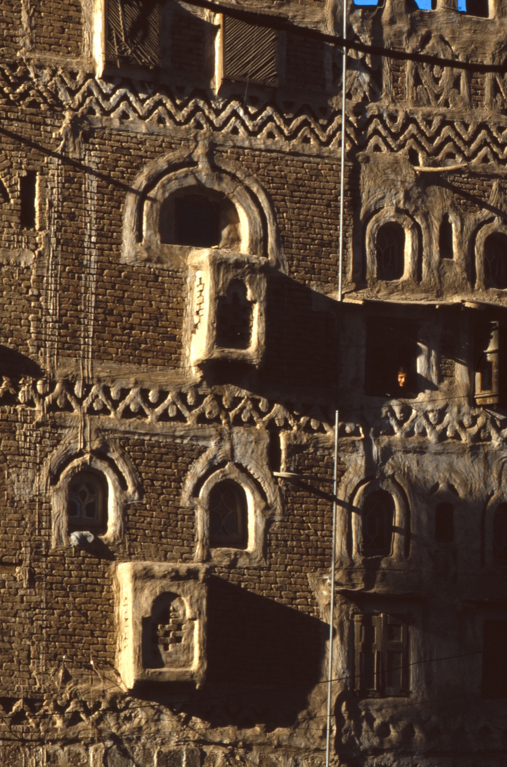 Sana'a. Depiction of a bricked building in Old Sana'a with ornamental bands of stucco work. 