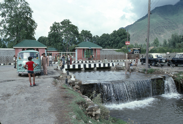 View of garden entrance flanked by two pavilions and final cascade in central channel as it flows into Bod Dal (Dal Lake).