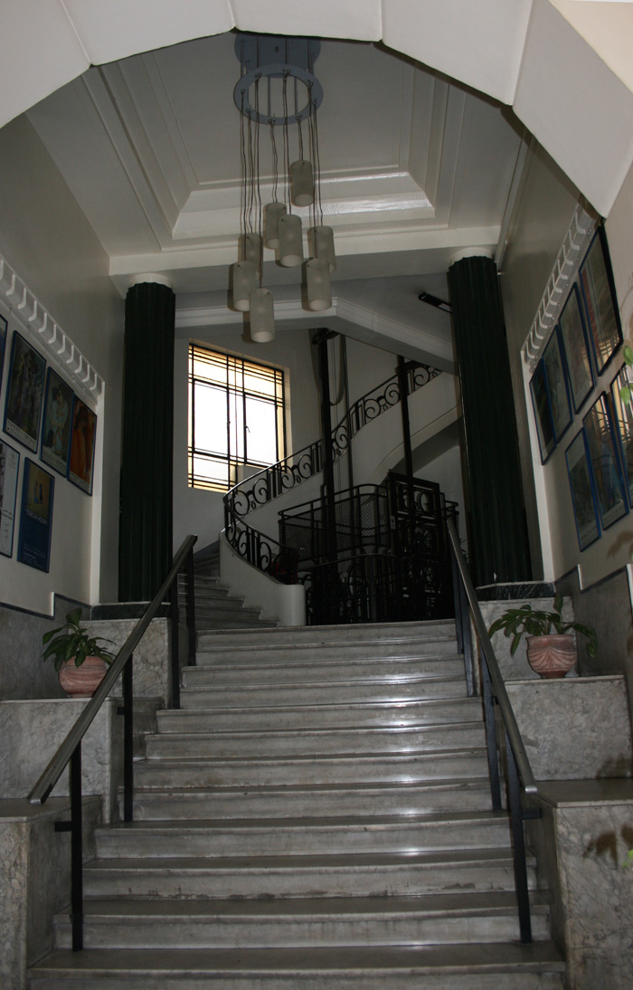 The hall opens onto a first marble set of stairs with Neo-classical columns which leads up to a staircase