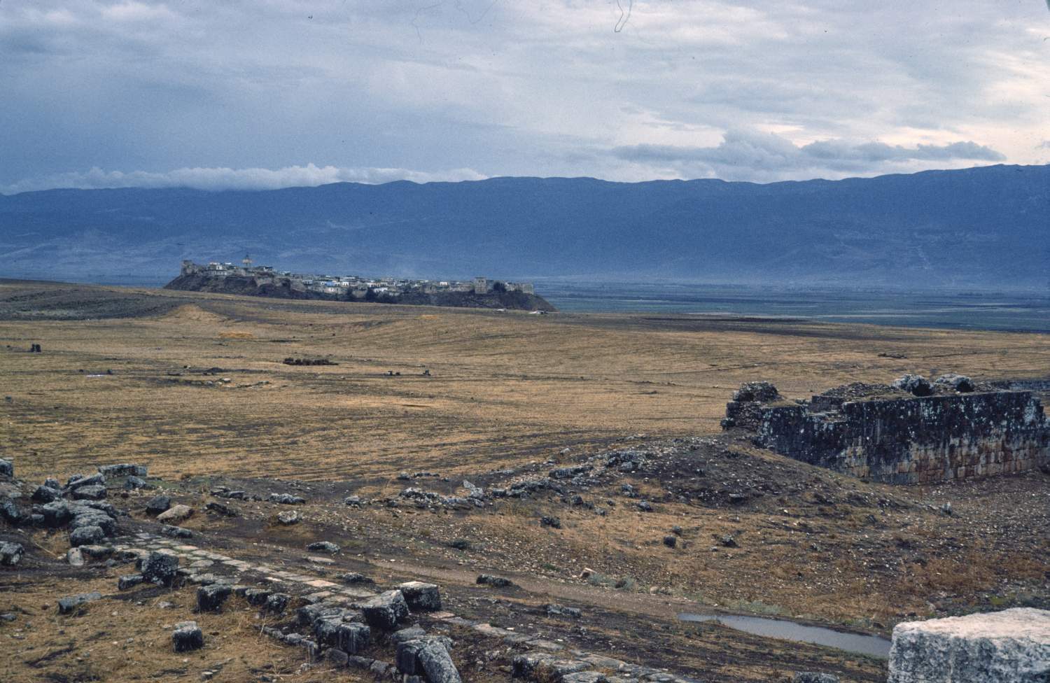 General view over site looking west toward Ghab Valley and Ansariyya Mountains, with hilltop village of Qal'at al-Mudiq visible.