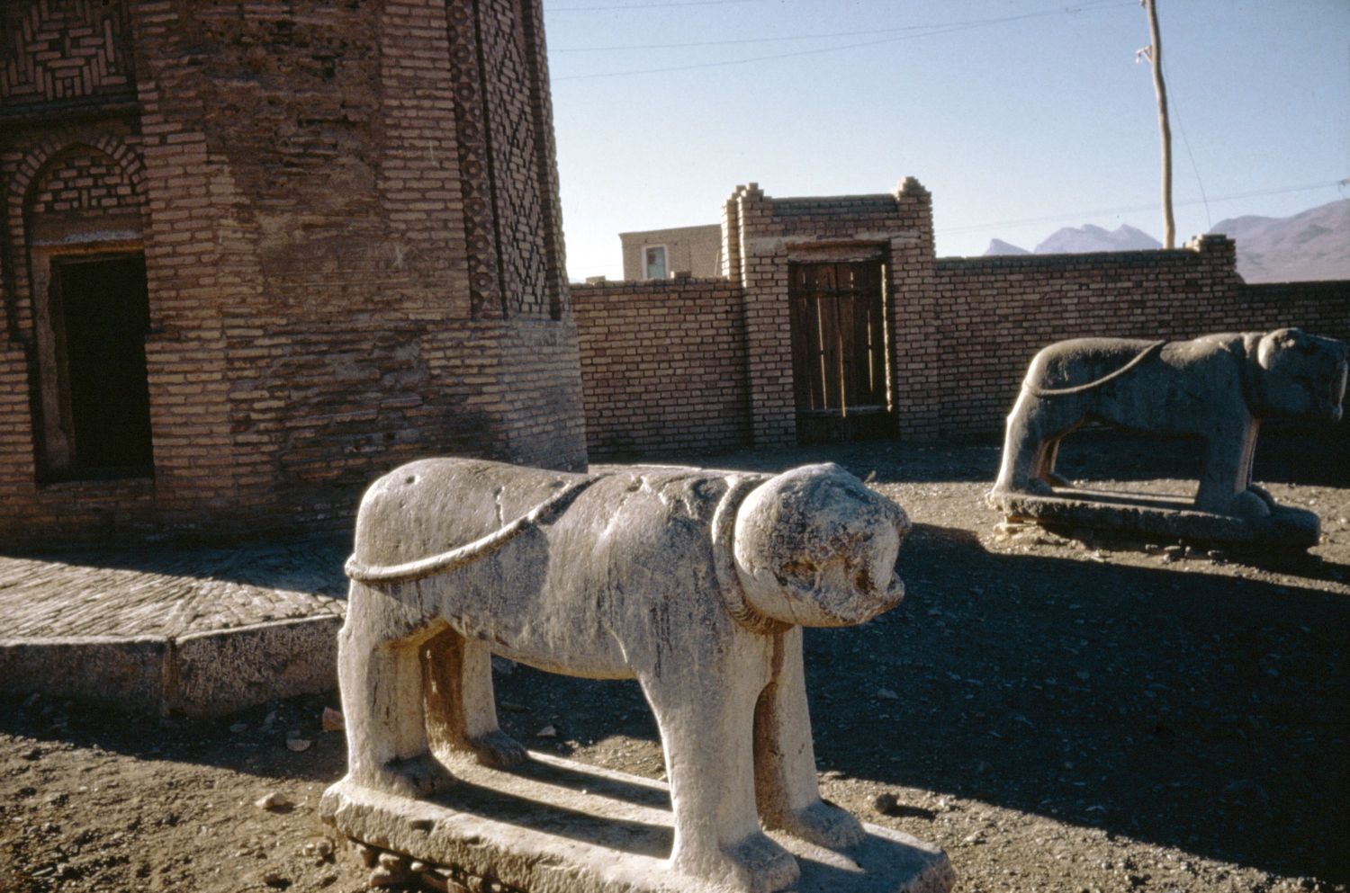 Stone lion sculpture at the base of a minaret in Gulpayagan, Iran.