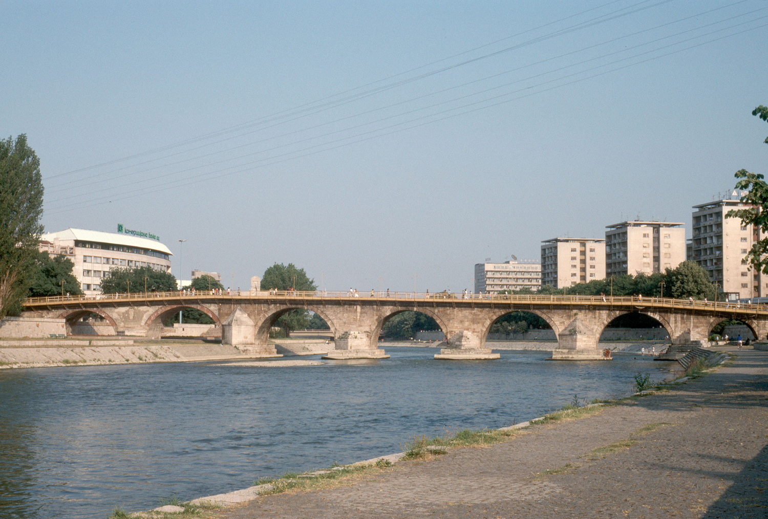 General view of the full bridge span looking west from the northern bank of the Vardar River