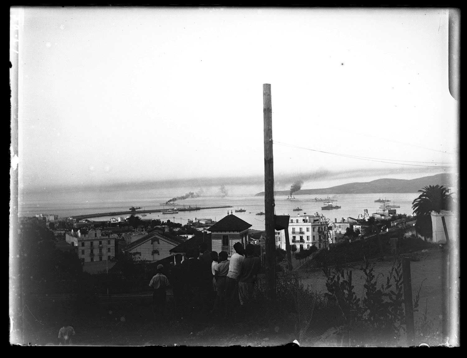 View of the harbor from higher ground to the south, children in the foreground