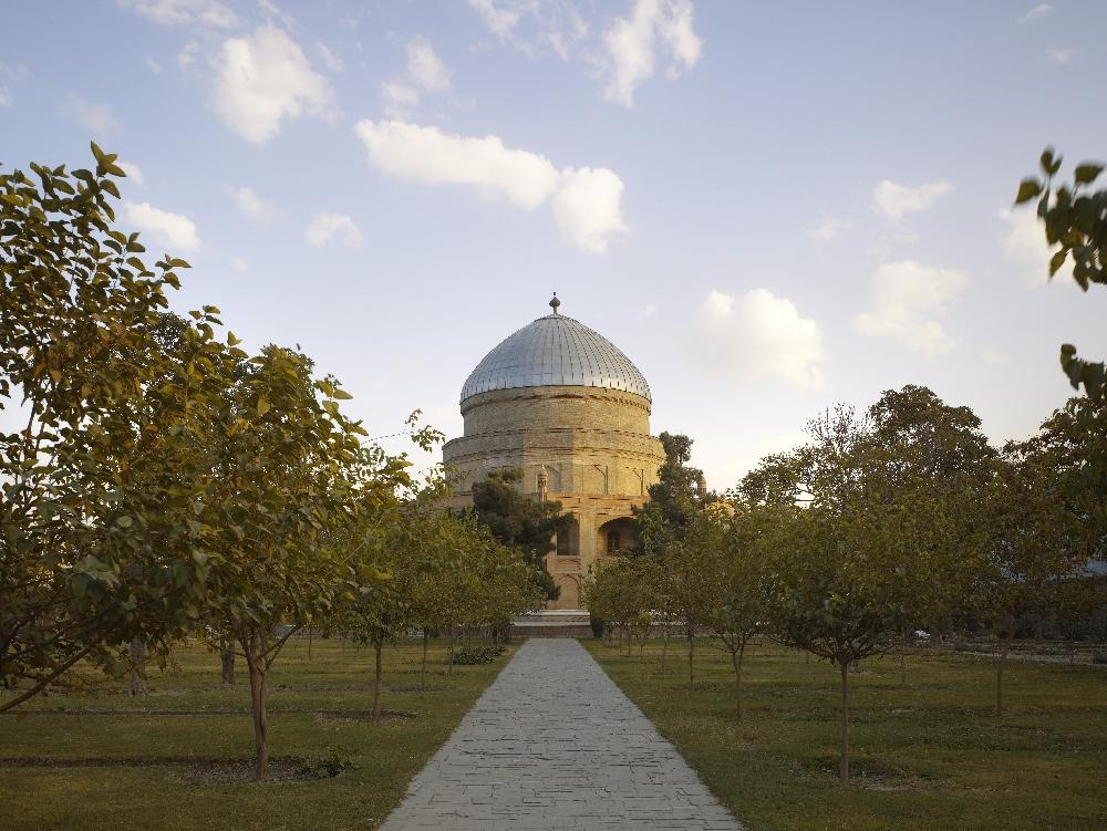 View of the restored mausoleum from the main pedestrian access, showing the reclaimed public park it is located within