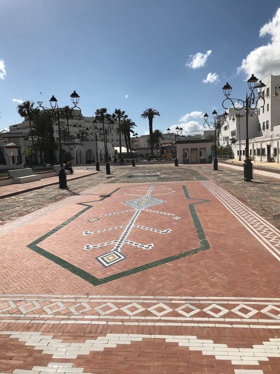 <p>View of the brick and tile mosaic paving the square</p>