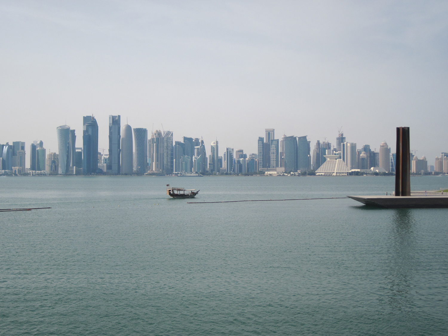 Doha - Skyline with dhow and Richard Serra sculpture (MIA Park)