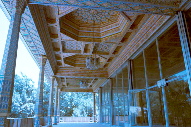 <p>Exterior view showing intricate wood worked ceiling and columns</p>