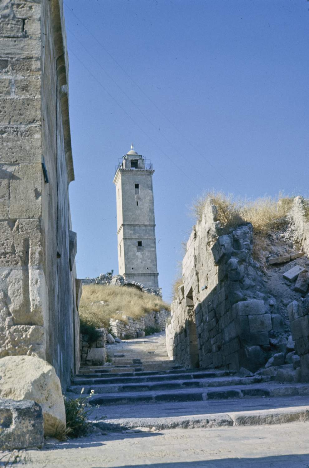 View of minaret from south, at bottom of path leading to mosque.
