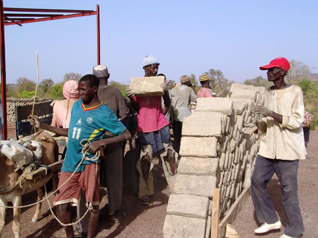People transporting stabilized soil block