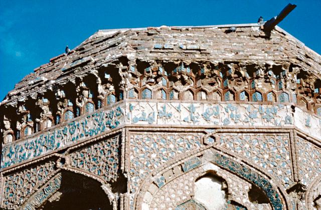Gunbad-i Qabud - Exterior detail showing terracotta and turquoise faience tiles used in the muqarnas cornice, inscription band, spandrels of arch, and the inscription band running along arch