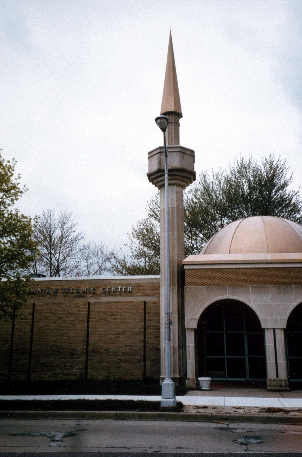 Albanian Islamic Center - Partial view of front entrance with dome above and minaret