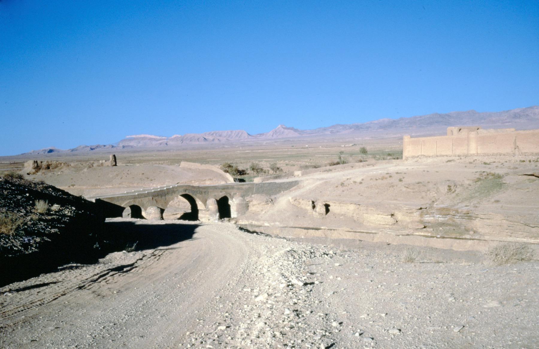 General view with bridge at center and caravanserai at right
