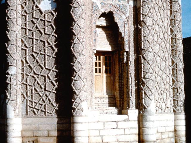 Exterior detail showing brick pattern of interlacing pentagons covering the lower portion of entire exterior surface