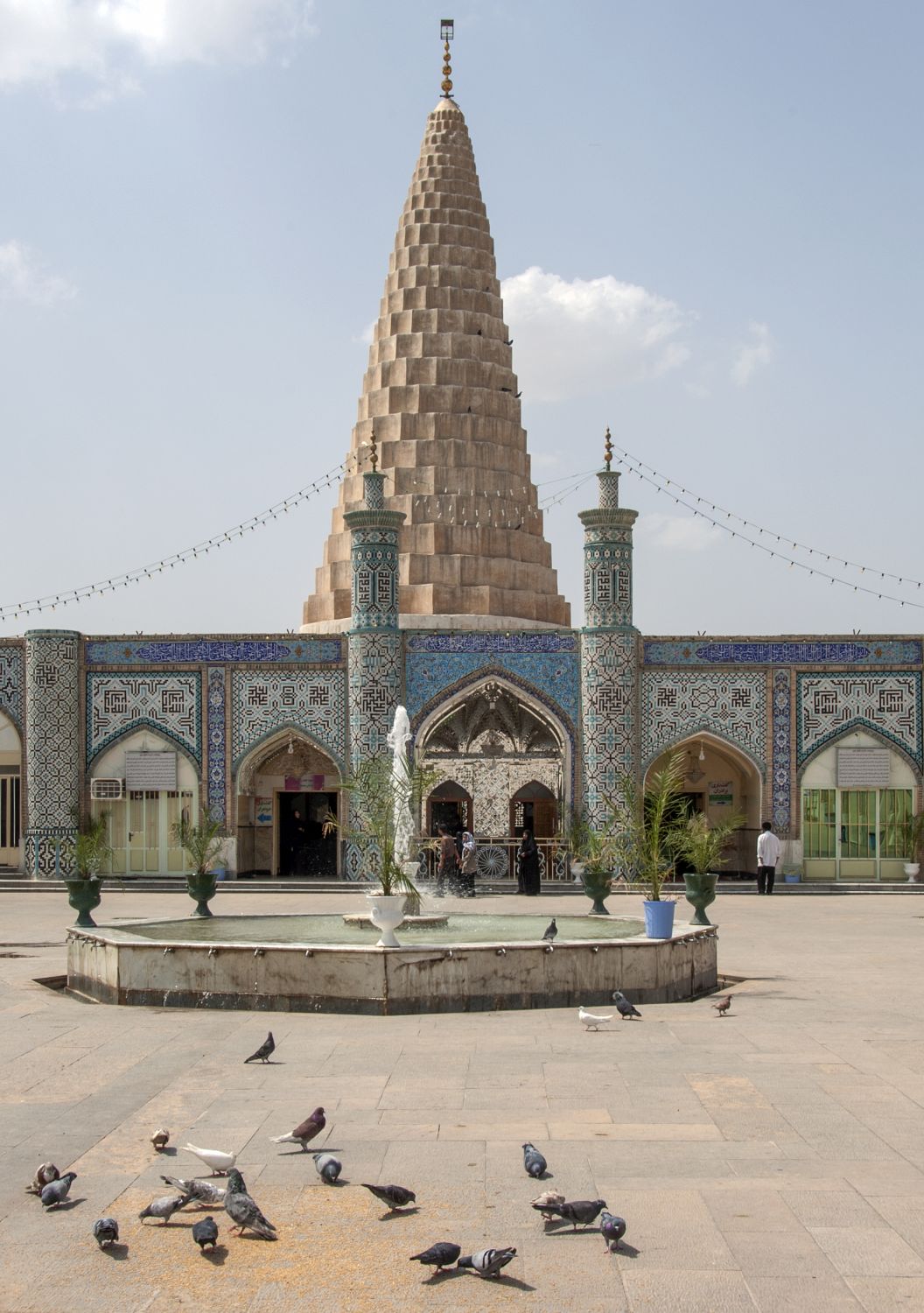 View of forecourt showing fountain and entrance to tomb chamber. Muqarnas dome rises in background.