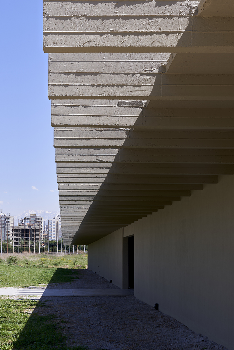 <p>From the outside, a paved concrete pathway leads the visitors discreetly towards the building entrance.</p>