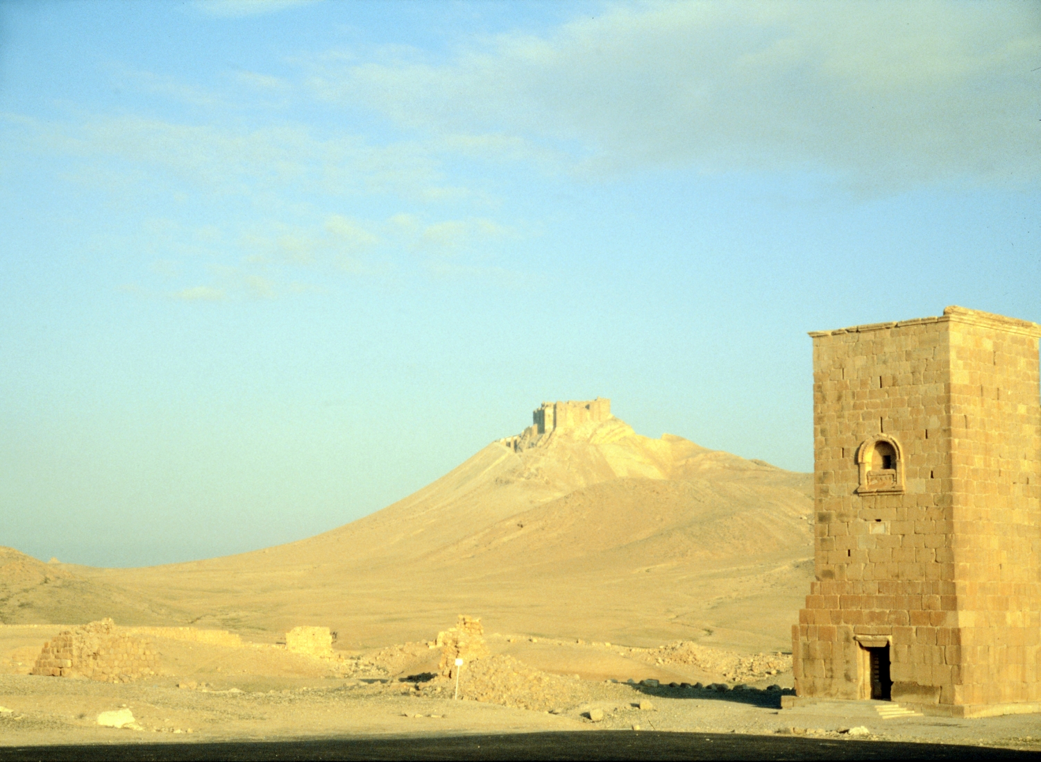 Elahbel Tower Tomb (aka Kubbet el 'Arus; Tower 13) Built 103/563 BH, destroyed August 2015/1463 AH. View of Qal'a ibn Ma'an in the distance.