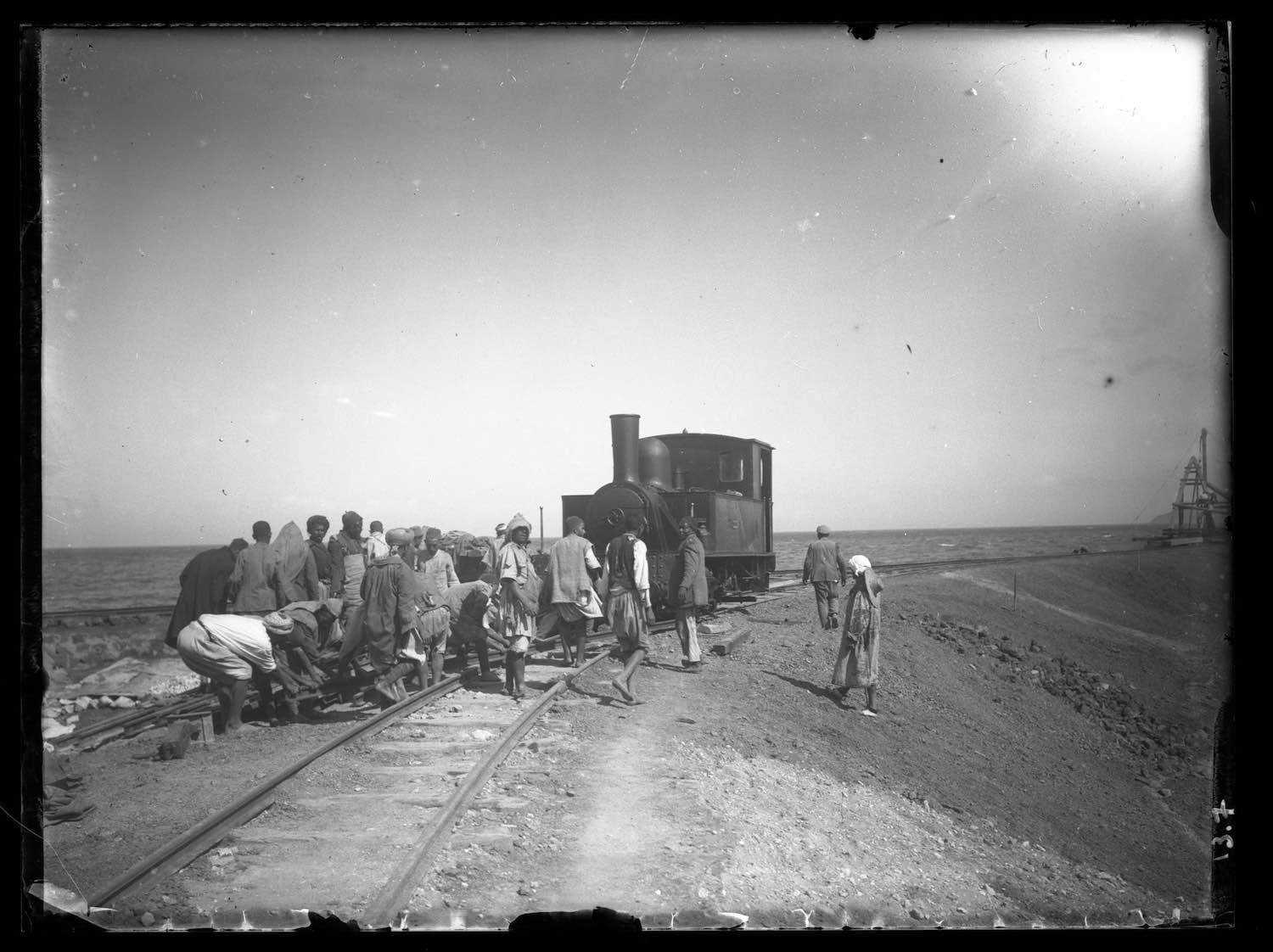 View of a group constructing the railroad line along the quai